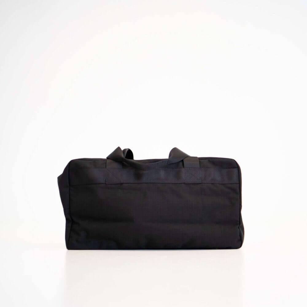 a black bag sitting on top of a white table.