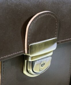 a close up of a brown briefcase with a metal handle.
