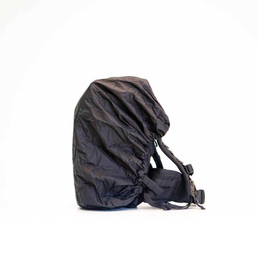 a black backpack sitting on top of a white floor.