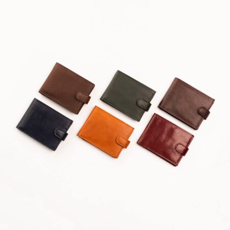 five different colors of leather wallets on a white background.