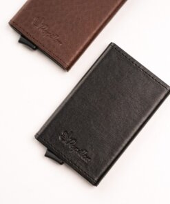 two wallets sitting next to each other on a white surface.