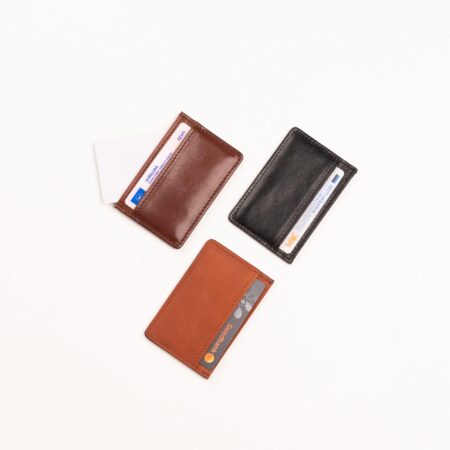 three different types of wallets on a white surface.