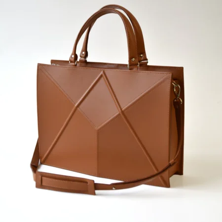 a brown handbag with a strap on a white background.