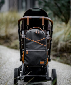 a stroller with a backpack strapped to the back.