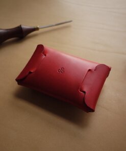 a red leather case sitting on top of a table.