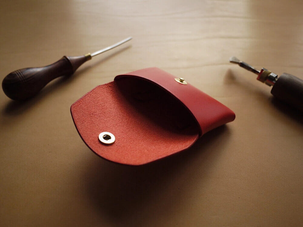 a red case sitting on top of a table next to a pair of scissors.