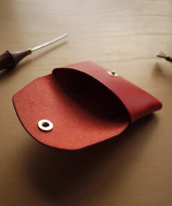 a red case sitting on top of a table next to a pair of scissors.