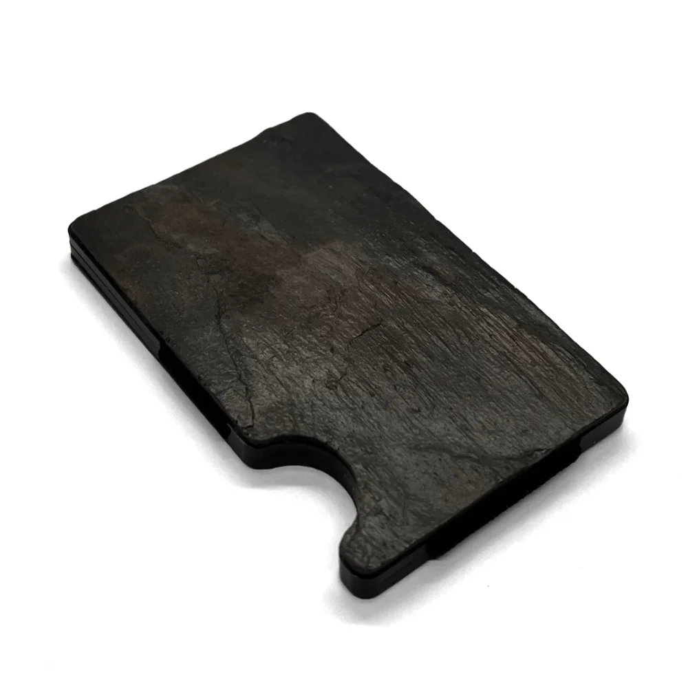a black piece of wood sitting on top of a white surface.