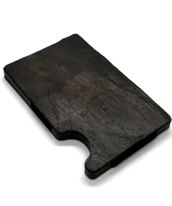 a black piece of wood sitting on top of a white surface.