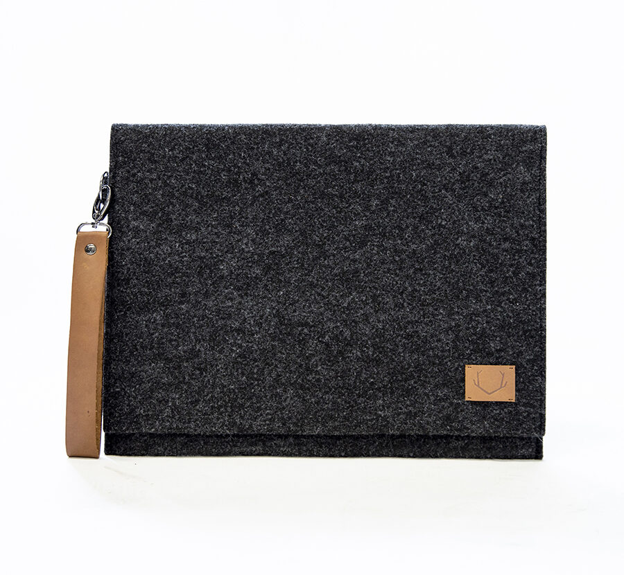 a black felt bag with a brown leather handle.