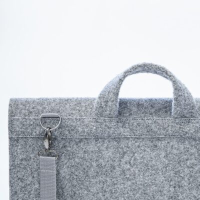 a gray felt briefcase with a silver handle.