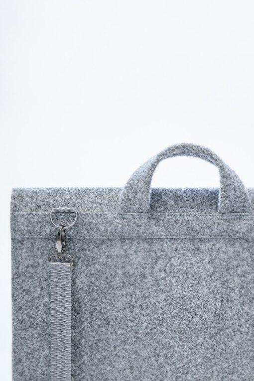 a gray felt briefcase with a silver handle.