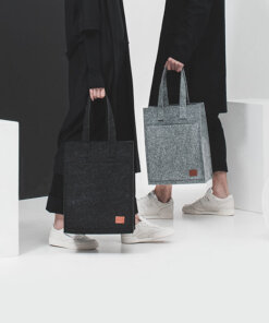 a couple of people with bags standing next to each other.
