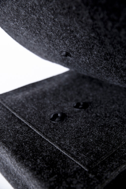 a close up of a black object on a white surface.
