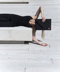 a woman laying on top of a white bench.