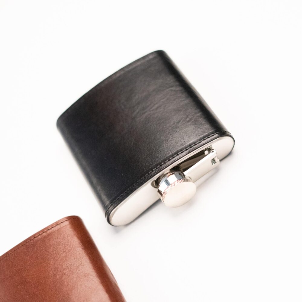 a black and white leather flask with a white button.