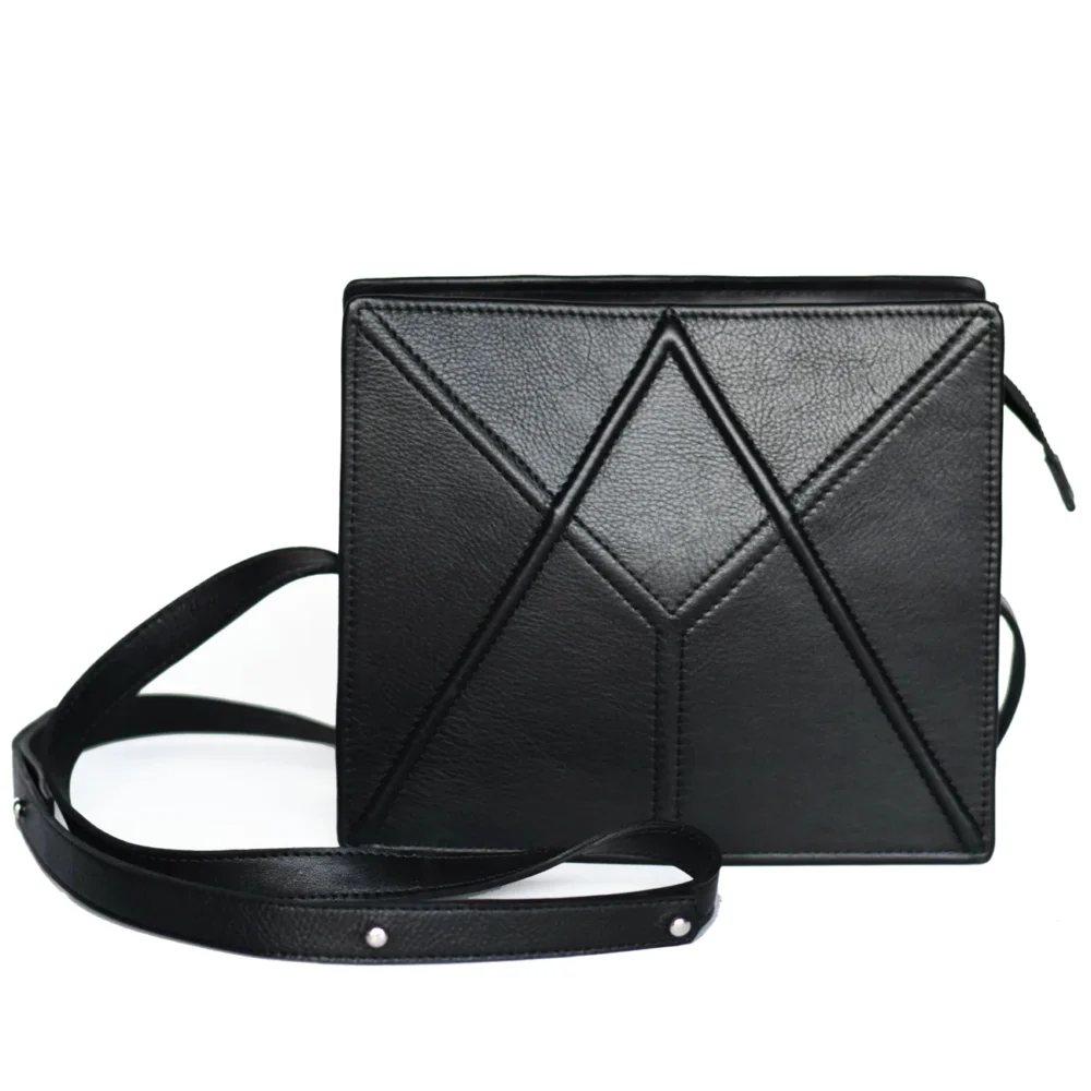 a black purse with a strap on a white background.