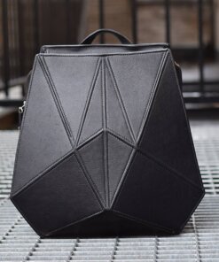 a black bag sitting on top of a tiled floor.