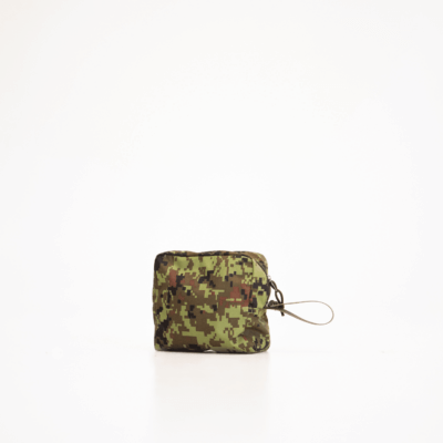 a green and brown camo pouch sitting on a white surface.