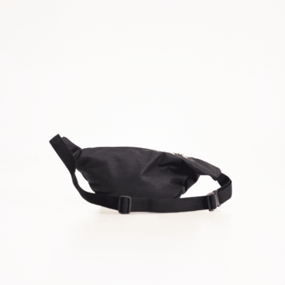 a black bag is sitting on a white surface.