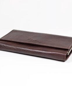 a brown wallet sitting on top of a white table.