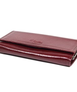 a red wallet sitting on top of a white surface.