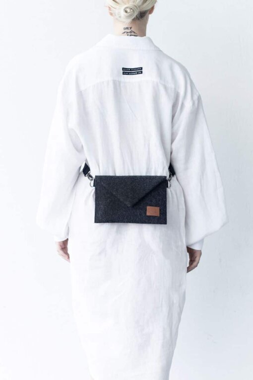 a woman wearing a white robe with a black belt.