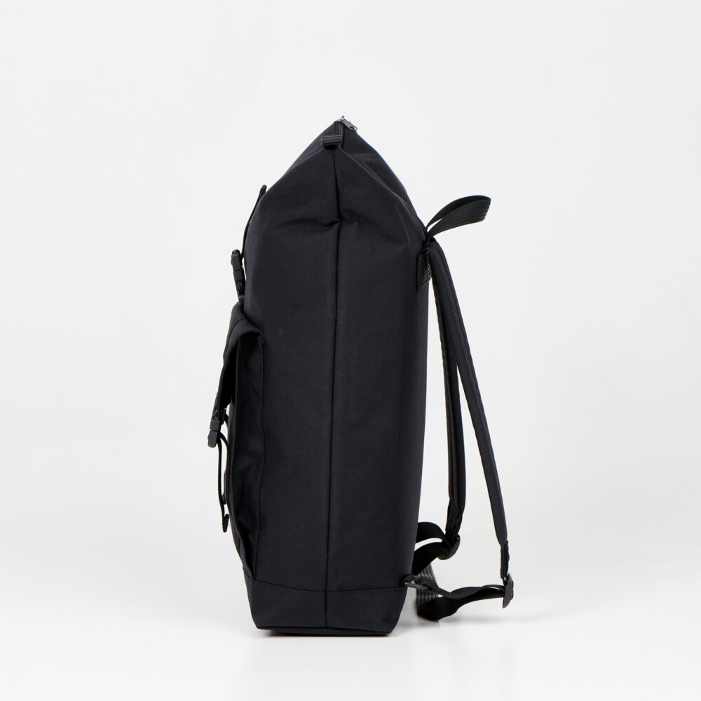 a black backpack sitting on top of a white floor.