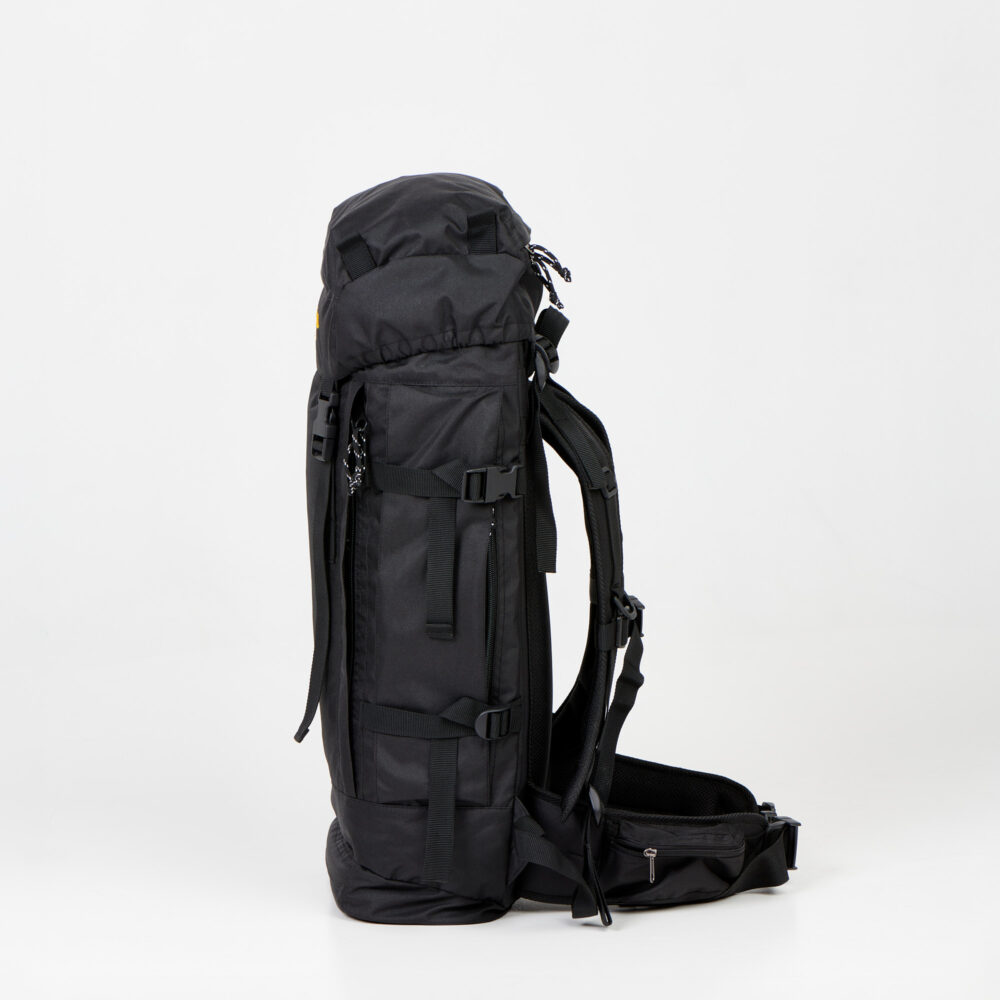 a large black backpack sitting on top of a white floor.