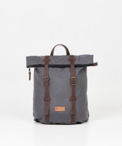 a gray backpack with a brown leather strap.