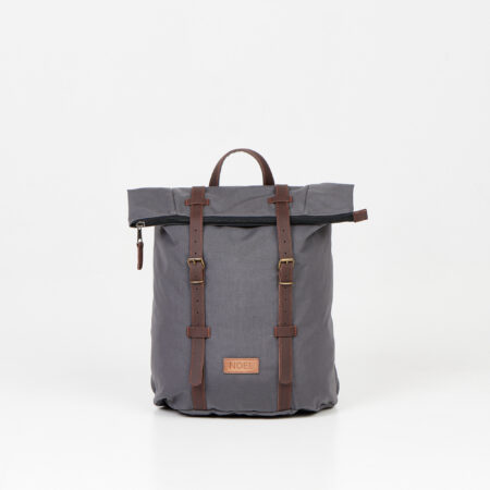 a gray backpack with a brown leather strap.