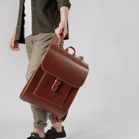 a man holding a brown leather briefcase.