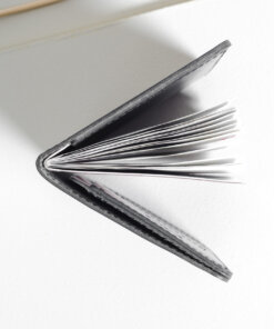 an open book sitting on top of a white table.