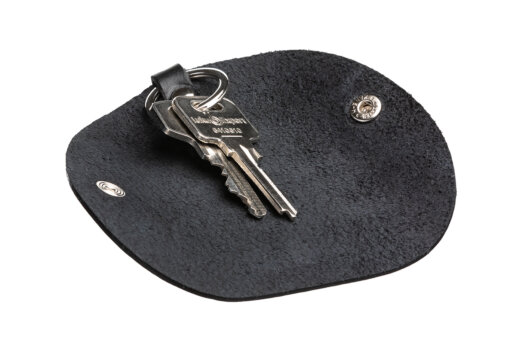 a pair of keys sitting on top of a black mat.