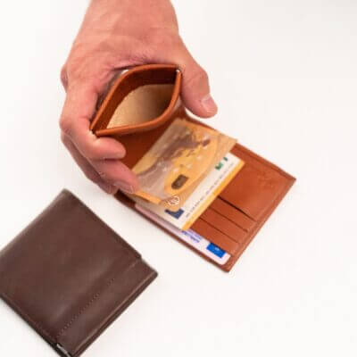 a person holding a wallet and a credit card.