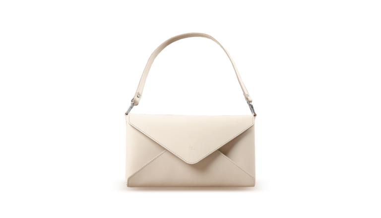 a white handbag with an envelope on the front.