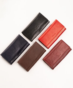four different colors of leather wallets on a white surface.