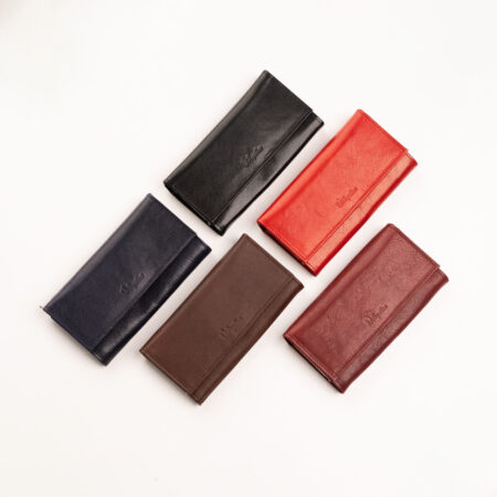 four different colors of leather wallets on a white surface.