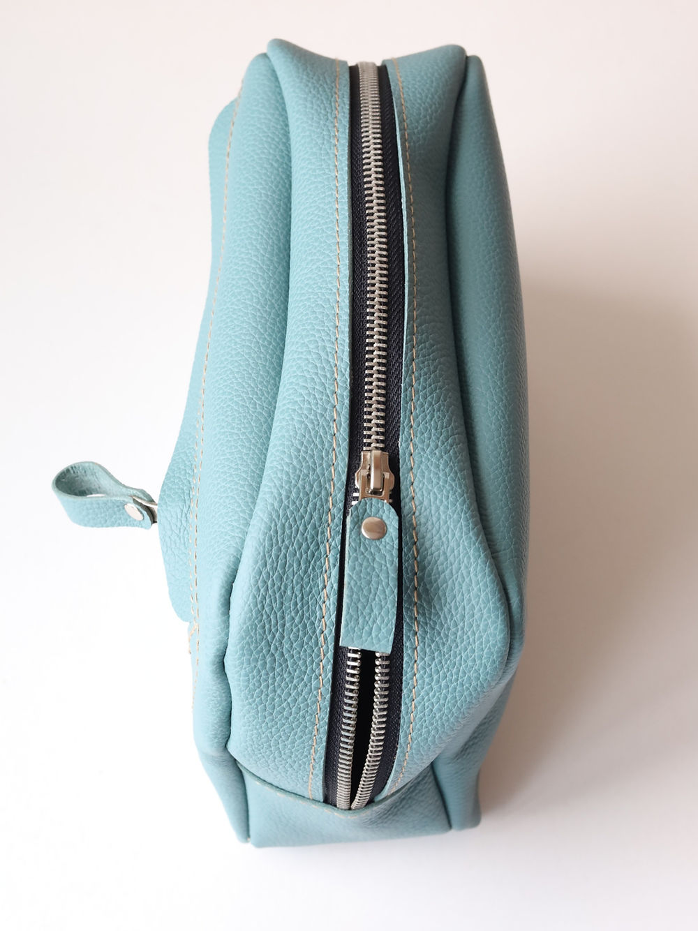 A DOUGLAS Toiletry Bag - Turquoise on a white surface.