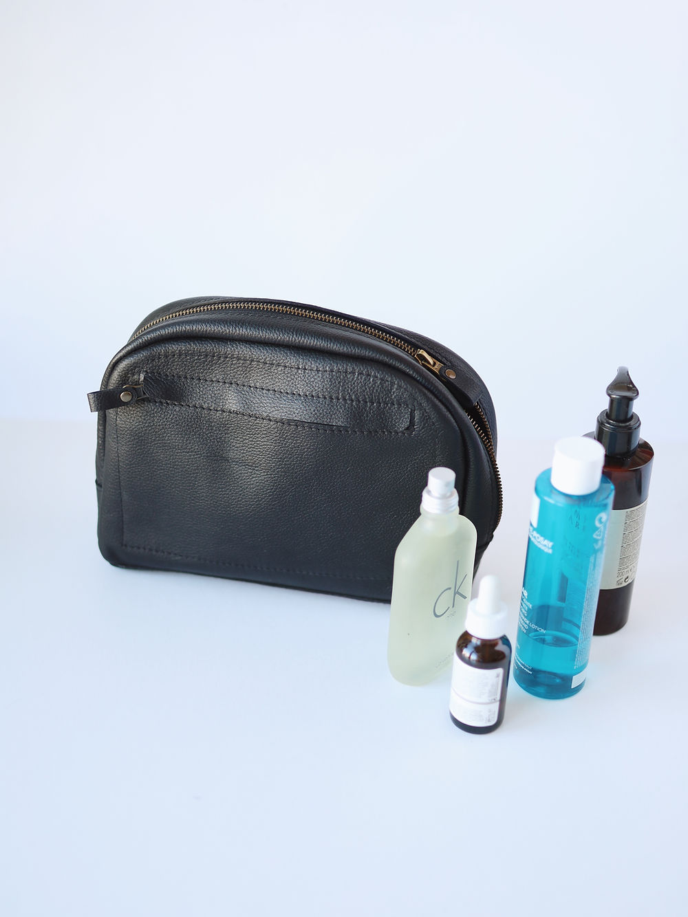 A DOUGLAS Toiletry Bag - Black with several items inside.