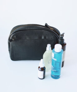 A DOUGLAS Toiletry Bag - Black with a bottle of water and a bottle of soap.