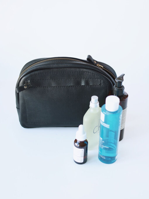 A DOUGLAS Toiletry Bag - Black with a bottle of water and a bottle of soap.