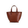 A Model Bucket - Cognac leather tote bag on a white background.
