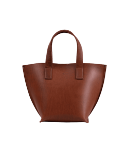 A Model Bucket - Cognac leather tote bag on a white background.